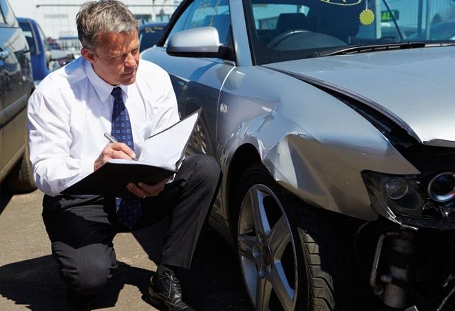 family car parked in driveway with insurance documents